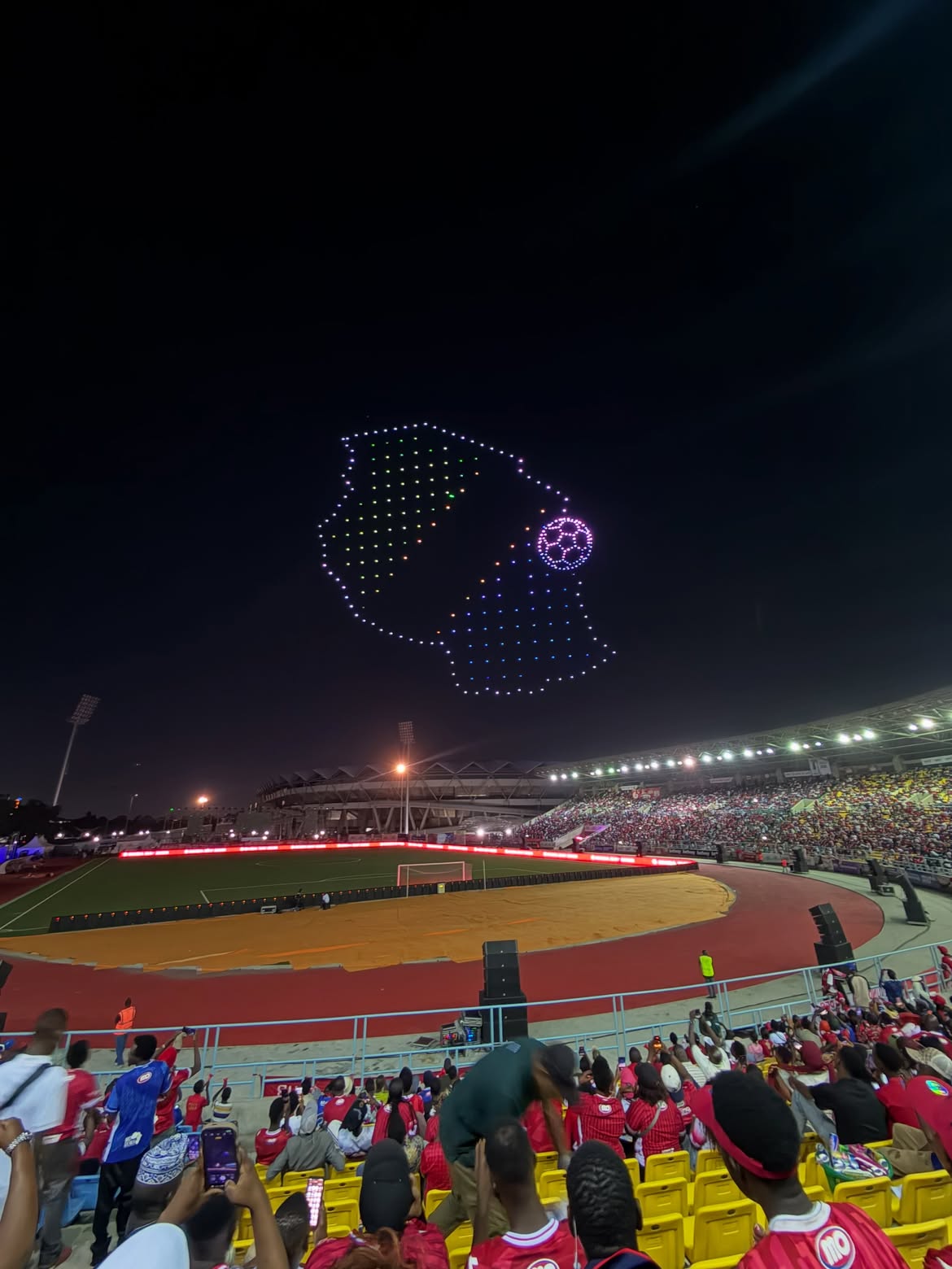 Drone light formation over a crowd at night
